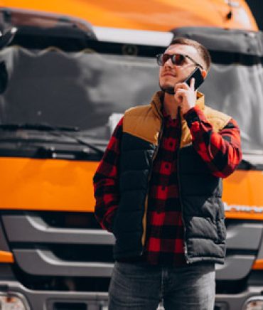 handsome-man-truck-driver-standing-by-the-truck